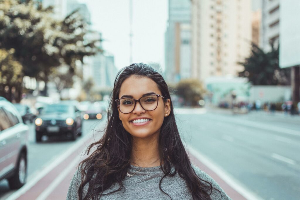woman smiling in the street | dental implants at Norcross GA dentist